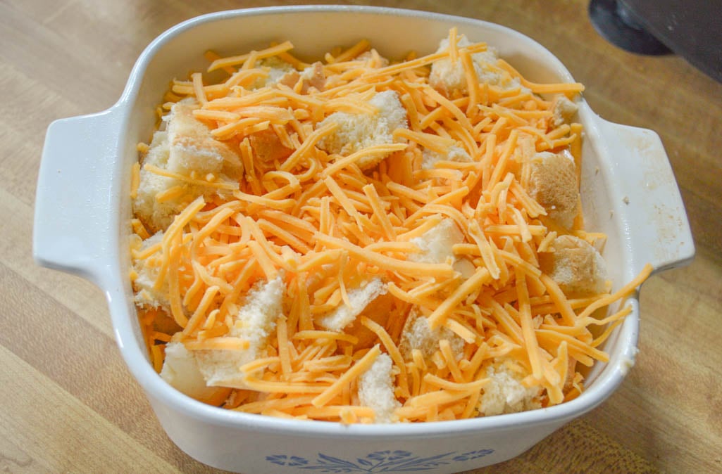 This Cheesy Egg Casserole is an easy recipe to put together the night before and adding your favorite breakfast meat and vegetables can make it even better.