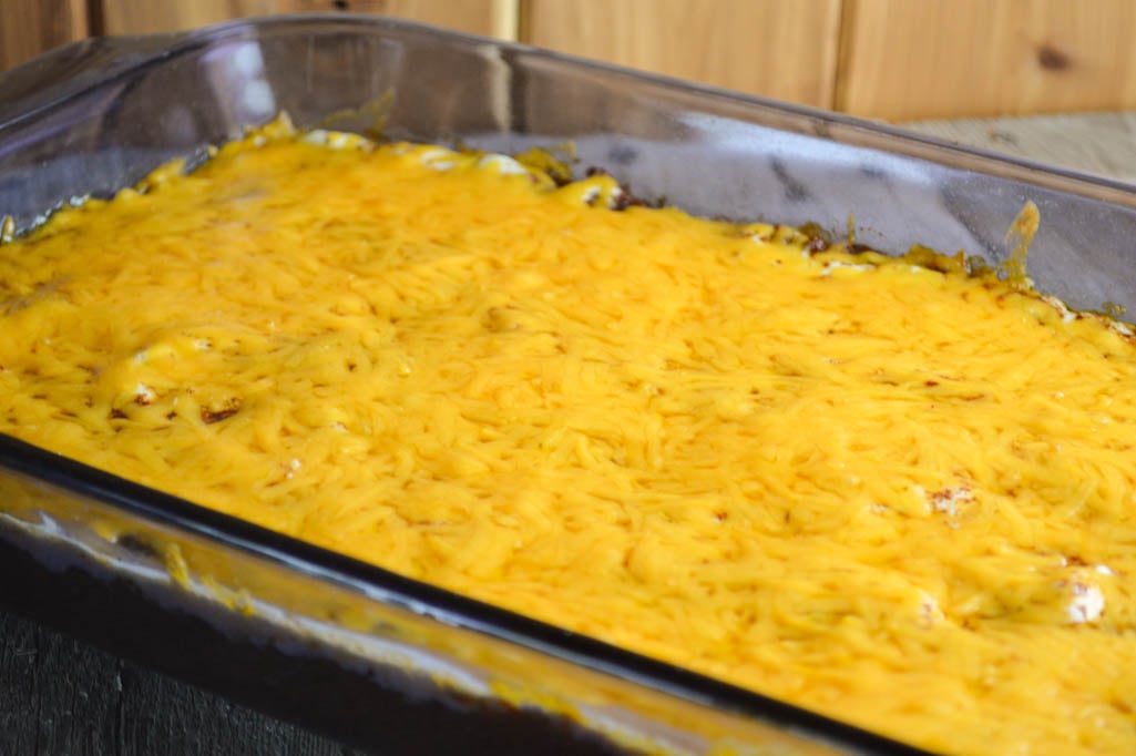 Cheesy Taco Dip is full of flavor and a great addition to any party or game day spread. Grab a bag of tortilla chips and you are ready to enjoy.