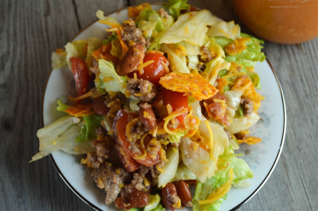 This Taco Salad with Homemade Dressing is perfect for your next pitch-in or as a fun weeknight dinner for the family.