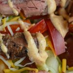 By adding taco seasoning to both the marinade and the dressing, this Flank Steak Salad is a family-pleasing meal with simple additions like Doritos.