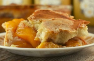This Peach Batter Cake recipe is super easy summer peach cake to make with either fresh or canned peaches and has a decadent crust that will have everyone asking for seconds.