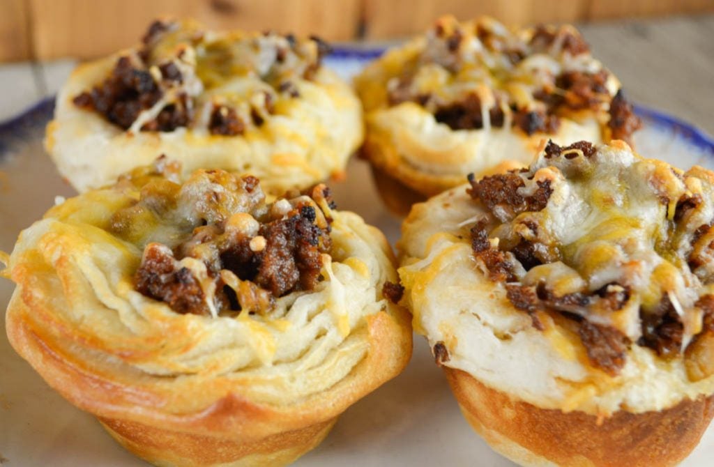 Sloppy Joe Cups have all the flavor of the classic sandwich in an easier to eat package - a biscuit - and topped with yummy cheese.
