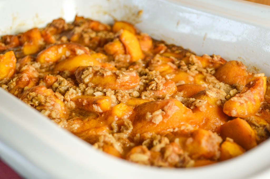 This Crock Pot Peach Cobbler may be the easiest dessert around because all the ingredients get dumped into the slow cooker insert and mixed together.