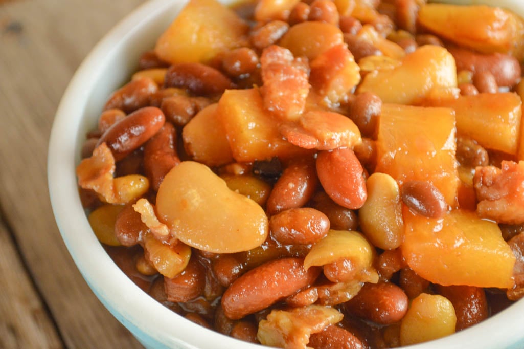 These Crock Pot Baked Beans with Pineapple are a new take on a family favorite side dish. The pineapple chunks give each bite a burst of sweetness.