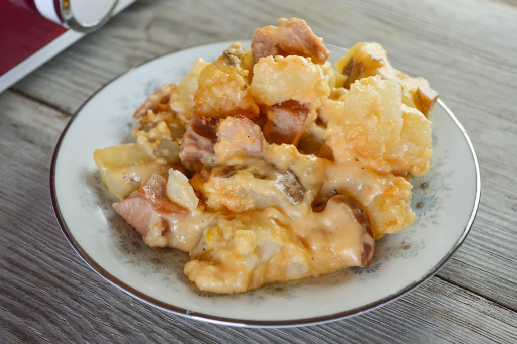 Crock Pot Cheesy Smoked Sausage and Potato Bake is comfort food at its best with a creamy cheese sauce topping family-pleasing ingredients.