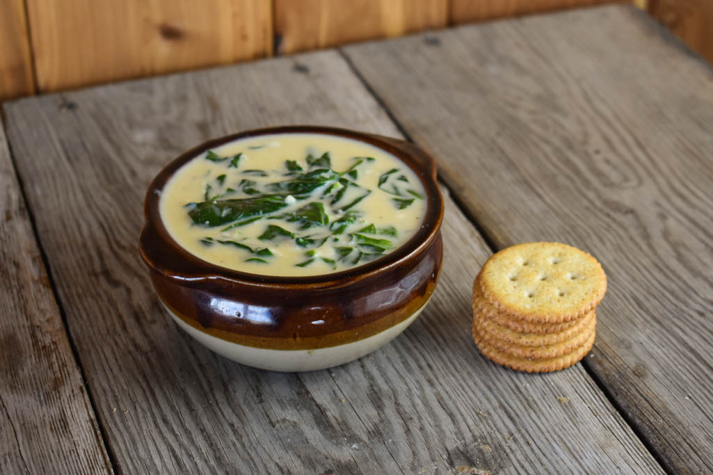 This Bavarian Spinach Beer Cheese Soup is a rich, cheesy soup full of spinach and crab. With Velveeta and Alfredo sauce, this soup is smooth and perfect served with a stack of your favorite crackers.
