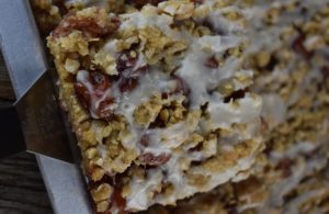 Glazed Oatmeal Cherry Bars recipe is easy to make for a perfect dessert choice. Using cherry pie filling, these dessert bars feature a buttery brown sugar and oatmeal crust and topping.  Cherry Bars with cherry pie filling are great to feed a crowd.