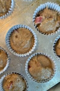 This Rhubarb Muffins recipe is quick and easy to make. With both whole wheat and all-purpose flour, these rhubarb-applesauce muffins are perfect for breakfast or brunch with a cup of coffee. The kids can help mix together the batter and gobble these muffins up with a big glass of milk.