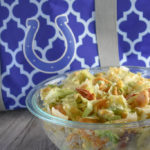 Cheesy Frito Salad is a great side dish option featuring corn chips, Velveeta and avocados.