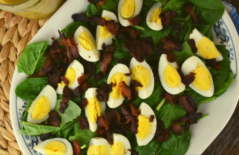 Classic Spinach Salad has three ingredients - fresh spinach, bacon and hard boiled eggs. It's topped with an easy spinach salad dressing.