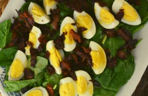 Classic Spinach Salad has three ingredients - fresh spinach, bacon and hard boiled eggs. It's topped with an easy spinach salad dressing.