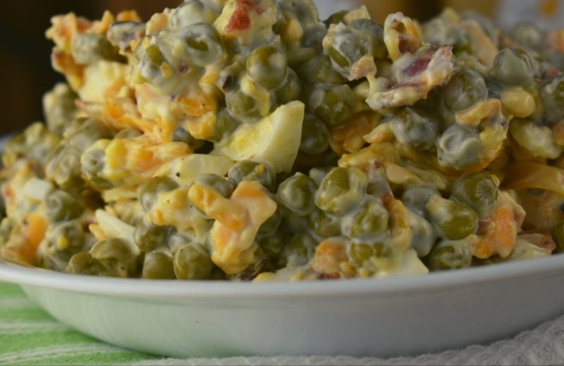 Easy Bacon Pea Salad is absolute perfection. The simple mixture of peas, bacon, shredded cheddar cheese, hard boiled eggs and mayonnaise marries together into the perfect summertime salad fit for any picnic or family get-together.