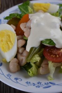French Dinner Salad is a classic French bistro salad with romaine lettuce, hard-boiled eggs, tomatoes, green beans, potatoes and Great Northern beans.
