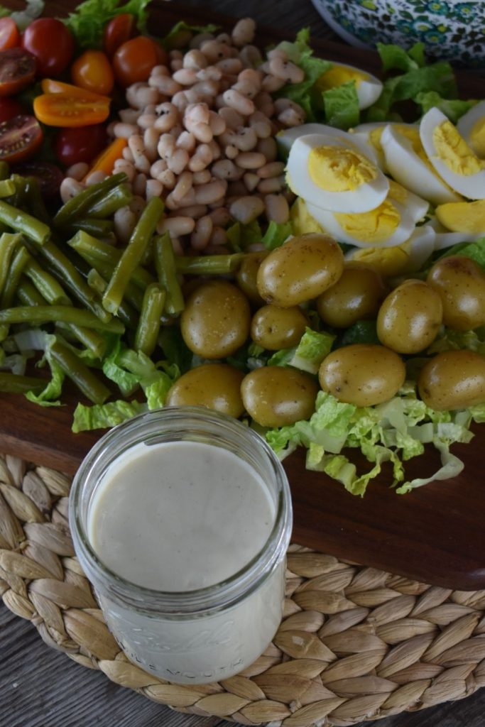 The multitude of toppings is what makes this French Dinner Salad is delicious, including green beans, great northern beans, hard boiled eggs and boiled potatoes.