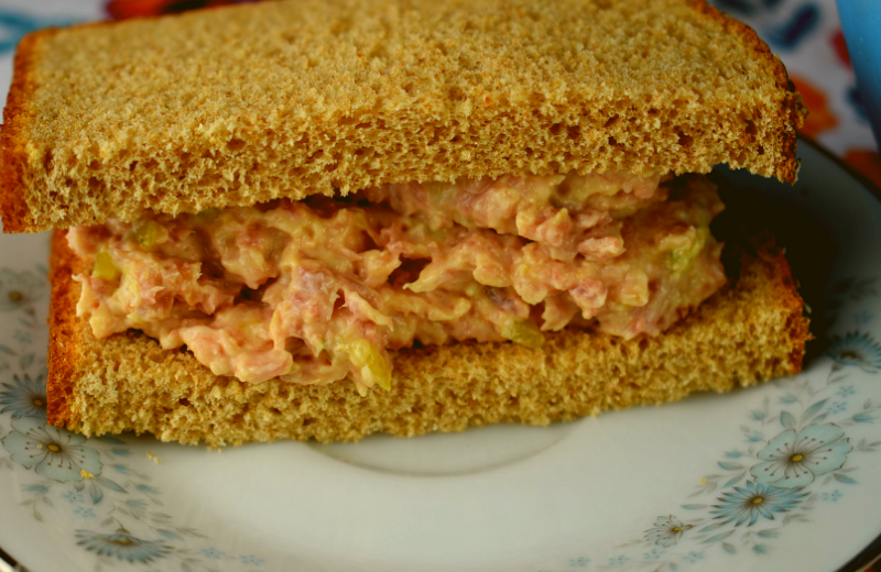 Old Fashioned Ham Salad Spread is just 5 simple ingredients that will take you right back to your childhood---leftover baked ham, miracle whip, yellow mustard, sweet pickle relish and sugar. Served on a sandwich or crackers, it's always a hit. 