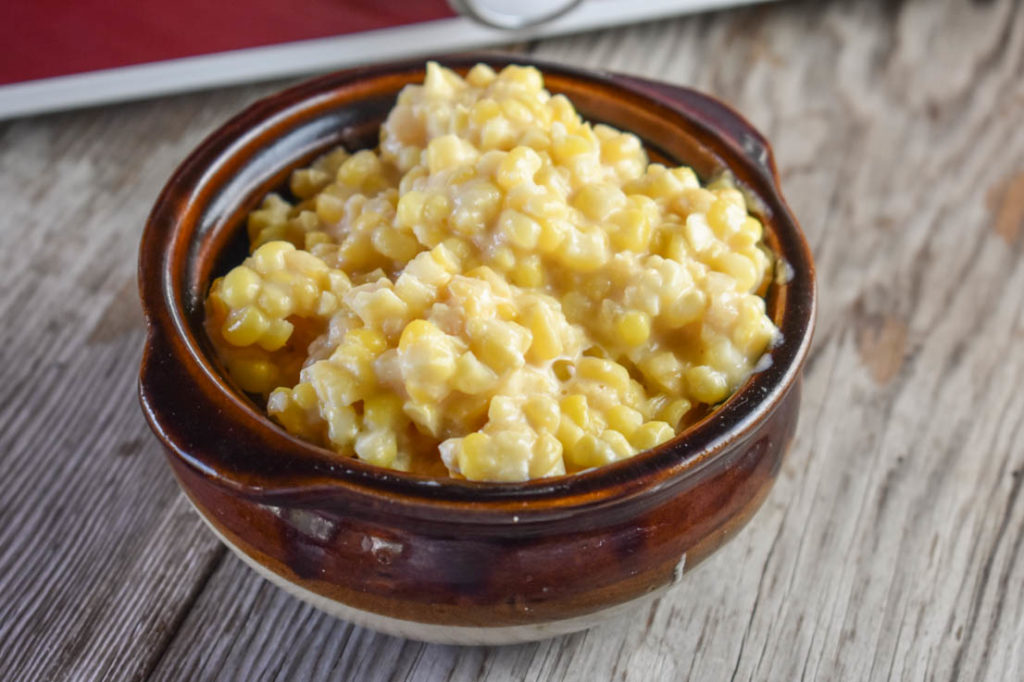 Using the crock pot, including a casserole version, is a great way to easily make crock pot cheesy corn for a crowd.