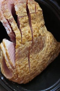 Brown Sugar Crock Pot Spiral Ham will be your family's new favorite way to prepare a holiday ham.  The best part of this family-pleasing recipe is that it only has 3 ingredients---spiral ham, brown sugar and yellow mustard.
