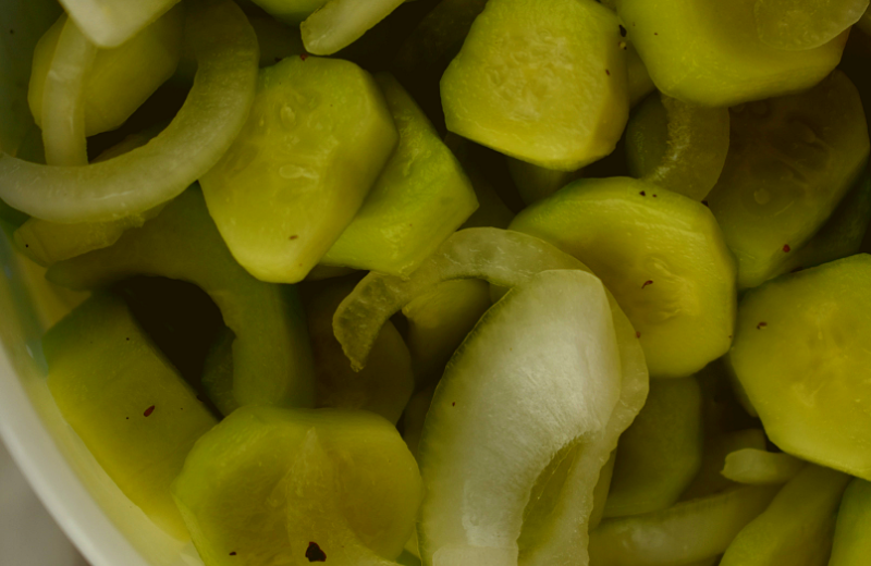 Mom's Cucumber and Onions is an old fashioned recipe featuring simple garden vegetables.  The ingredients are simple--cucumbers, onions, salt, vinegar, sugar, celery seed and black pepper, but the finished result is the perfect accompaniment to any summer meal.