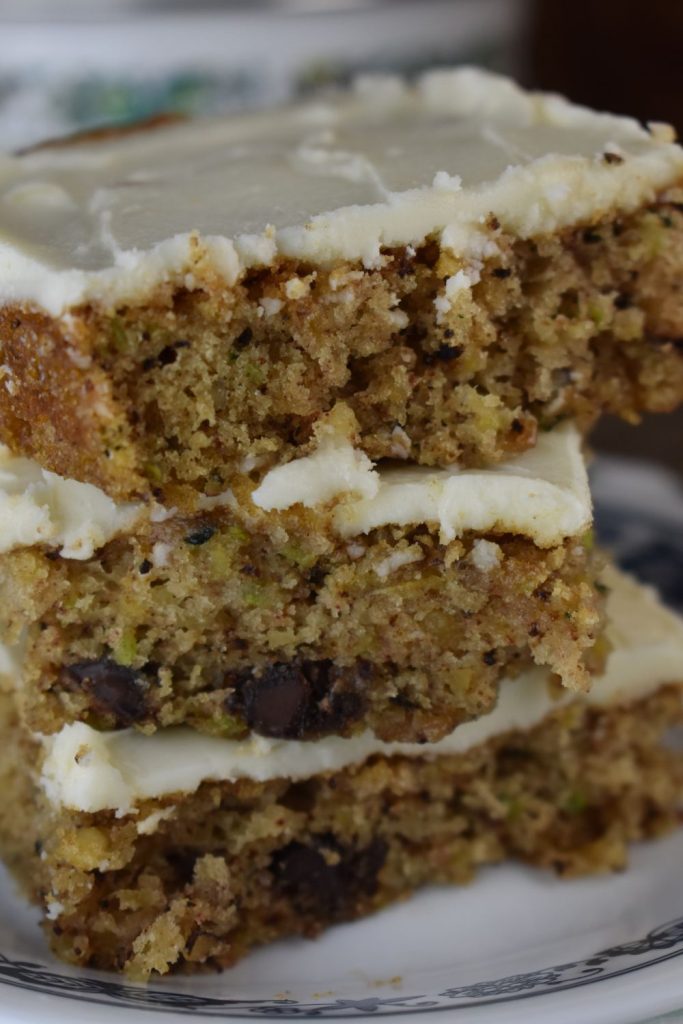 Frosted Zucchini Bars with Chocolate Chips are perfect dessert to use up summer zucchini. These delectable zucchini bars features a tasty cream cheese icing, a moist texture and a rich chocolate chip flavor. Plus, it feeds a crowd!