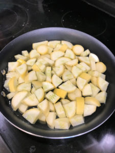 Add diced yellow squash to skillet for Kentucky Squash Casserole.