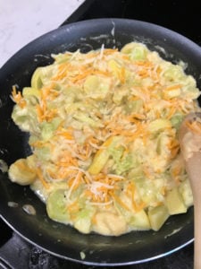 Add remaining ingredients to the skillet with the yellow squash for the next step in Kentucky Squash Casserole.