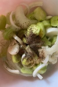 Mom's Cucumbers and Onions is an old fashioned recipe featuring garden vegetables.  The ingredients are simple - cucumbers, onions, salt, vinegar, sugar, celery seed and black pepper, but the finished result is the perfect accompaniment to any summer meal.