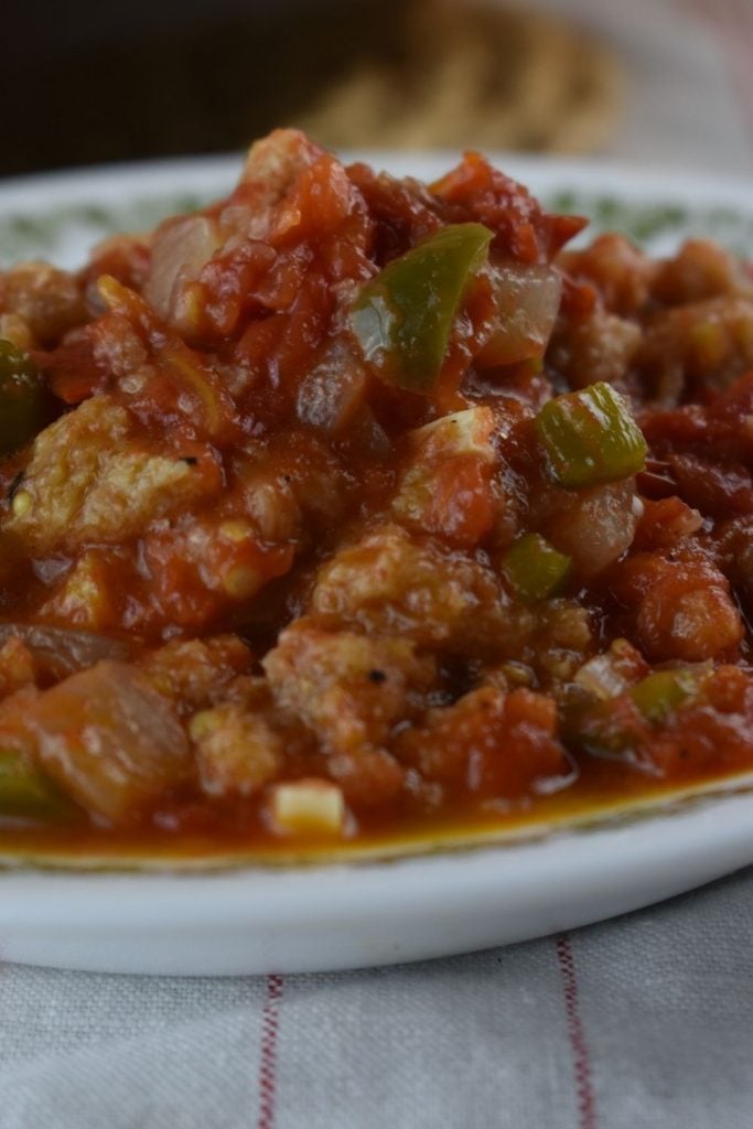 Old Fashioned Stewed Tomatoes are a treat for your taste buds.  Sweet garden tomatoes are cooked slowly with onions, green peppers and butter to form a rich sauce which is soaked up with chunks of bread.  This is the perfect accompaniment for any summer meal. 