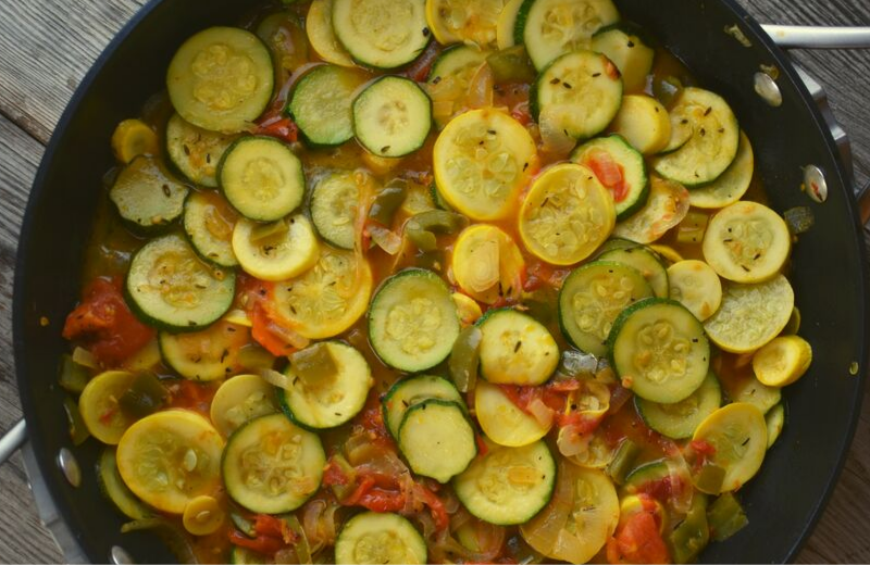 Stewed Summer Squash and Tomatoes is a light side dish that can be served along the meat of your choice or eaten alone for a vegetarian option.  A base of onions, tomatoes and peppers compliment zucchini and yellow squash, and it's made in one skillet, making kitchen clean-up a cinch. 