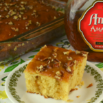 Amaretto Poke Cake isn't just for Amaretto lovers.  It's a moist cake that pairs great with coffee for breakfast or makes the most delicious dessert for all ages. It features a decadent Amaretto glaze that is poured over an amped up box caked mix.