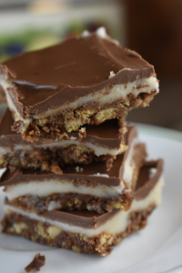 Grandma's Three Layer Chocolate Squares are a family favorite treat that are served every Christmas at my house.  The triple layer cookie bar consists of a chocolate graham cracker crust, a vanilla cream center and a sweet Hershey's chocolate topping. 