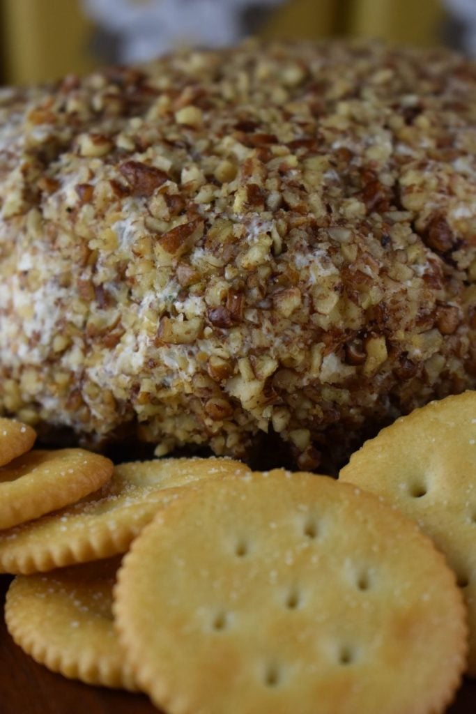 This Pineapple Cheese Ball with Pecans has a sweet pineapple flavor that goes hand in hand with the saltiness of chopped pecans. It comes together easily, and includes common ingredients - cream cheese, crushed pineapple, green pepper, onion, pecans an salt. Serve with crackers for a new favorite appetizer.
