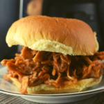 Crock Pot Sweet Pulled Pork features slow cooked pork in a special sweet sauce. This recipe uses a slow cooker, the best cut of meat for pulled pork and a yummy sauce inspired by our grandma. 