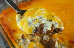 There are only 5 simple ingredients between you and this warm, cheesy Taco Dip with Meat and Beans.  Ground beef, re-fried beans, Ortego Taco Sauce, sour cream and shredded cheese are all you need.  This simple appetizer is soon to be your go-to for game day, holidays, family gatherings or Taco Tuesday.