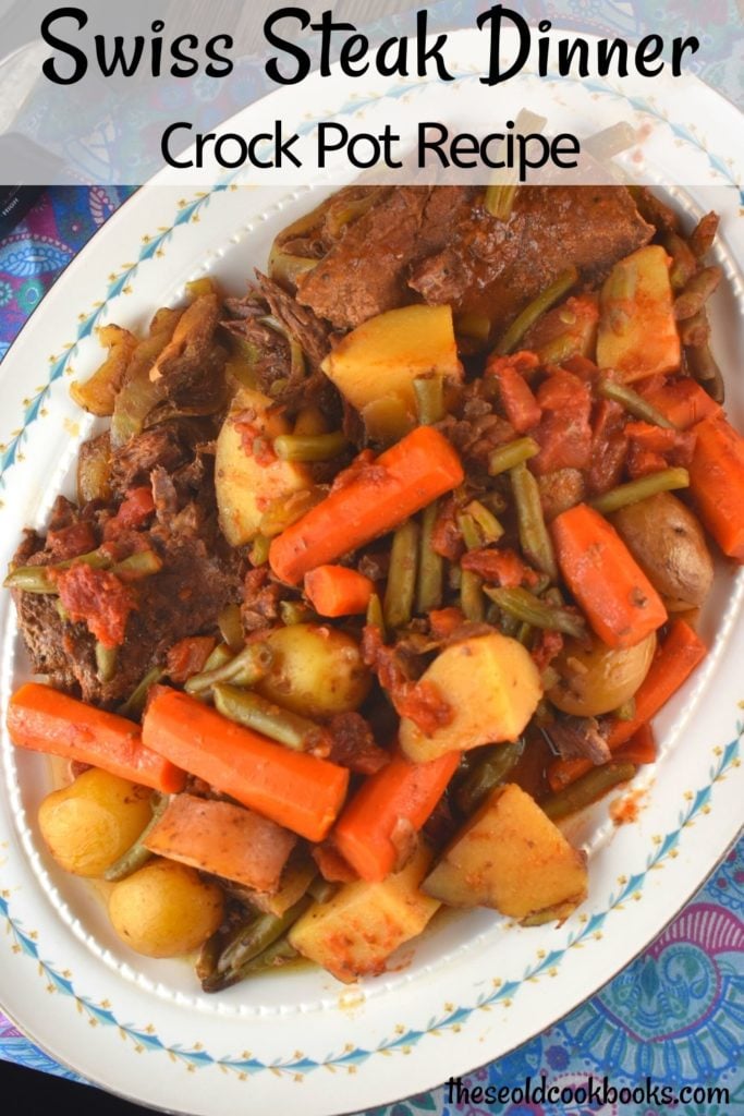 Crockpot Swiss Steak is a vintage recipe with a new spin. Slow cooking round steak results in a fork-tender cut of beef that pairs perfectly with carrots, potatoes and green beans for a complete meal.