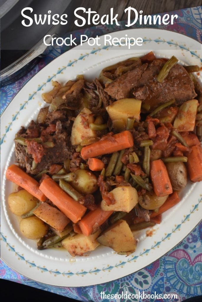 Crockpot Swiss Steak is a vintage recipe with a new spin. Slow cooking round steak results in a fork-tender cut of beef that pairs perfectly with carrots, potatoes and green beans for a complete meal.