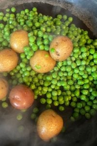 Creamed Peas and New Potatoes come together quickly on the stove top and pair perfectly along side any entrée.  This old fashioned creamed peas (without cream) dish tastes just like Mom or Grandma made it.