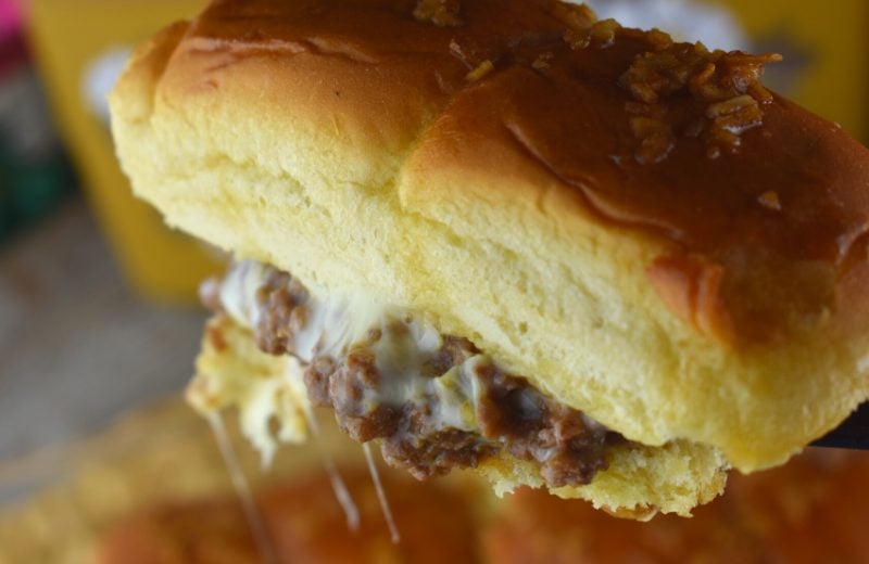 French Onion Sliders are a cheesy-topped ground beef sloppy Joe mixture baked on Hawaiian rolls and drizzled in an delectable butter sauce.