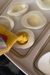 Grandma's Deviled Eggs are an old-fashioned version without relish. The creamy, yolk filling is a combination of sugar, vinegar, mustard and Miracle Whip. One bite of these will take you right back the holidays from your past.
