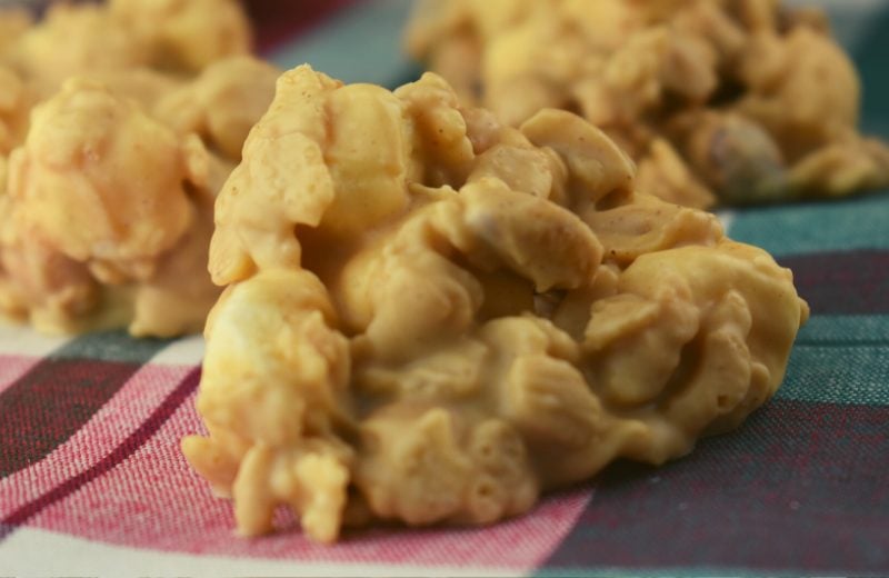 White Chocolate Peanut Clusters are a no bake peanut butter candy recipe that can be completed in less than 15 minutes.  The white chocolate peanut butter base coats a crunchy combination of peanuts and Rice Krispies that perfectly complements slightly melted mini marshmallows.