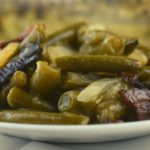Pennsylvania Dutch Green Beans are a German-inspired side dish. Canned green beans are enhanced with water chestnuts, onions and bacon and baked in a slightly sweet and tangy sauce.  These can be eaten right away or prepped the night before for the perfect holiday green bean recipe. 
