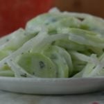 Simple Sour Cream Cucumbers is an old fashioned summer salad featuring garden cucumbers and onions. The sauce is a delightfully easy sour cream base flavored with with a pinch of tarragon. 