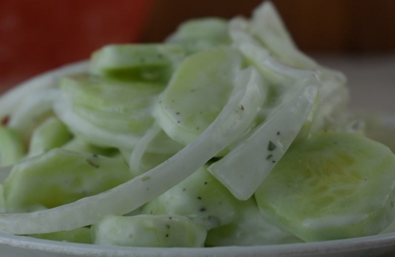 Simple Sour Cream Cucumbers is an old fashioned summer salad featuring garden cucumbers and onions. The sauce is a delightfully easy sour cream base flavored with with a pinch of tarragon.
