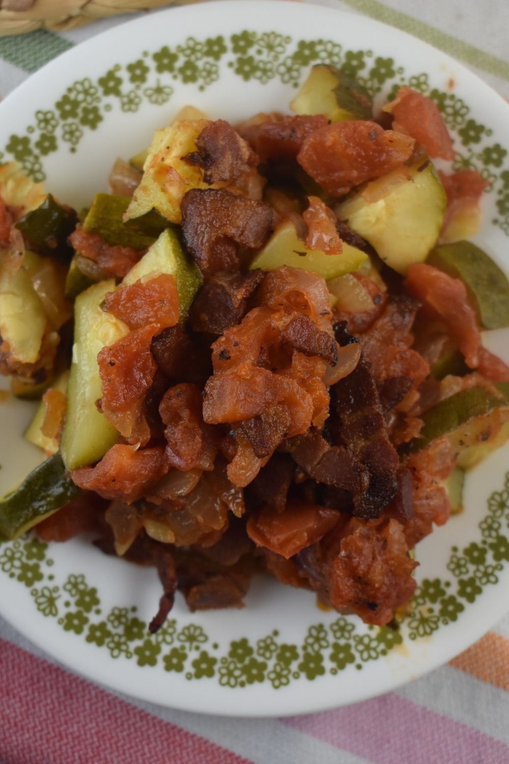 Zucchini Tomato Bacon Bake is the a new spin on zucchini casserole.  Chunks of zucchini are baked in a homemade marinara sauce and topped with crispy bacon.  Zucchini Bacon Casserole is the perfect addition to your meal.