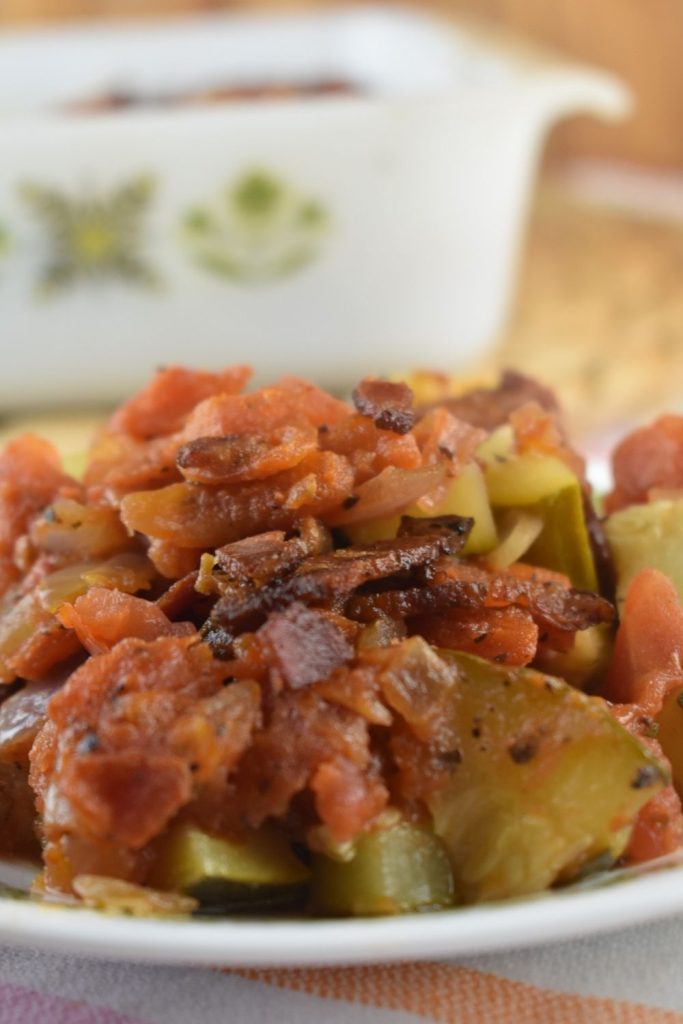 Zucchini Tomato Bacon Bake is the a new spin on zucchini casserole.  Chunks of zucchini are baked in a homemade marinara sauce and topped with crispy bacon.  Zucchini Bacon Casserole is the perfect addition to your meal.