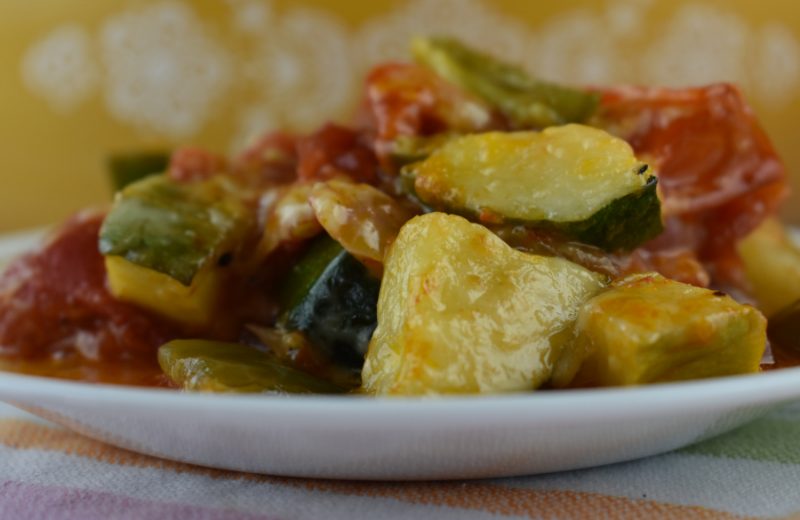 Healthy Zucchini Tomato Casserole includes a menagerie of fresh garden veggies sautéed together. Before serving this zucchini, tomato and onion casserole, a layer of shredded Parmesan cheese is melted over top for the perfect finishing touch.