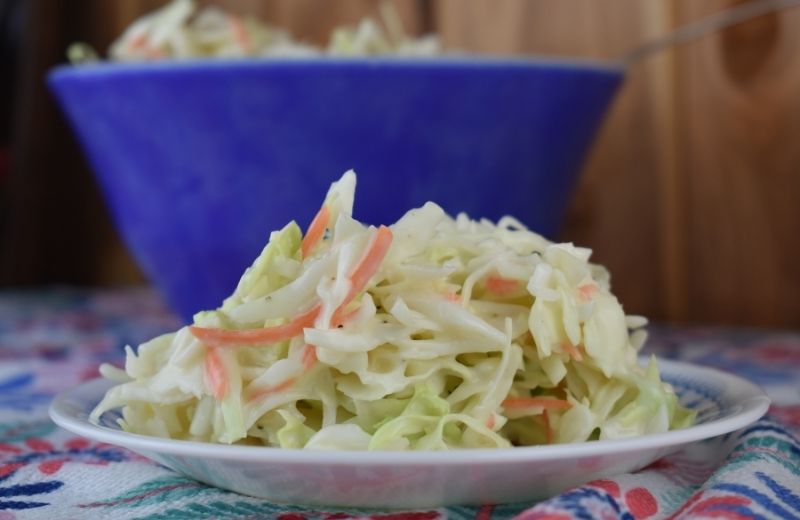 This homemade coleslaw dressing recipe is easy as can be with only four ingredients plus salt and pepper. Simple and Sweet Coleslaw goes together in a pinch for the perfect side dish.
