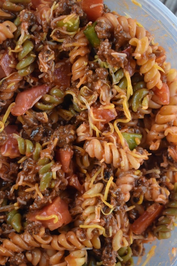Western Dressing Pasta Salad has all your favorite taco toppings. Containing hamburger and pasta, it's hearty enough to make a full meal.