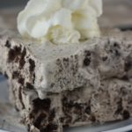 Oreo Ice Cream Cake is a perfectly easy 3 Ingredient Cookies and Cream Recipe.  This ice cream cake features chunks of your favorite Oreo cookie to create a cookies and cream inspired dessert.