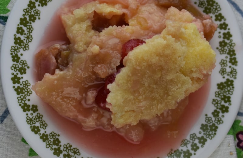 Cherry Rhubarb Crisp with sour cream is made in a 9x13 pan which serves a crowd.  Served alone or drizzle the rhubarb syrup over ice cream for an old fashioned dessert.  The addition of maraschino cherries in this rhubarb crisp makes it extra special.