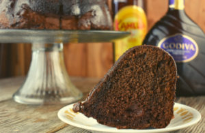 Chocolate Kahlua Bundt Cake is a light and airy double chocolate cake doused in a sweet, boozy glaze.  It starts with a two shortcut ingredients, cake mix and pudding mix but is jazzed up with two types of booze, Kahlua and Crème de Cacao. Traditionally, this boozy chocolate cake is called a Black Russian Cake.